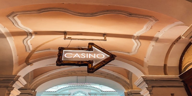 An arrow sign pointing the way to a casino. An arrow sign pointing the way to a casino.