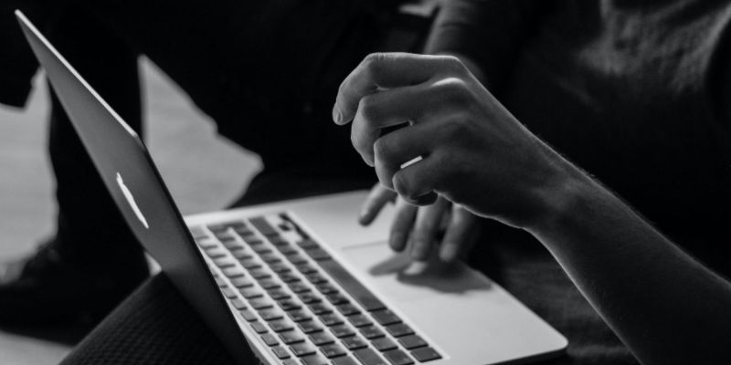 A black and white photo of a person’s hands operating a laptop; JackpotCity Casino Blog A black and white photo of a person’s hands operating a laptop; JackpotCity Casino Blog