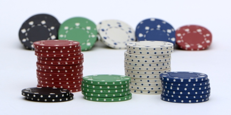 Stacks of casino chips against a white background; JackpotCity Casino Blog Stacks of casino chips against a white background; JackpotCity Casino Blog