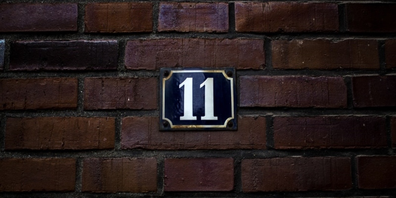Brick wall with number 11 sign