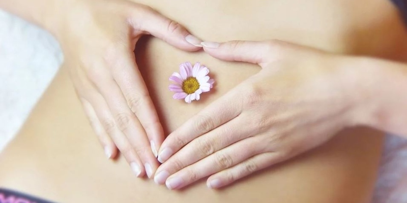 Woman with flowers on her belly; Spin Palace Blog