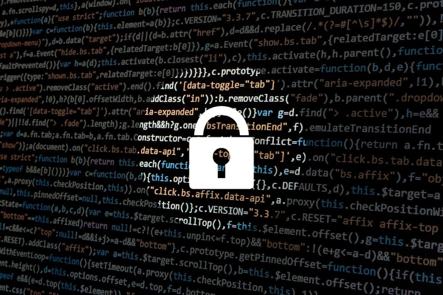 A cybersecurity padlock super-imposed over lines of computer code. A cybersecurity padlock super-imposed over lines of computer code.